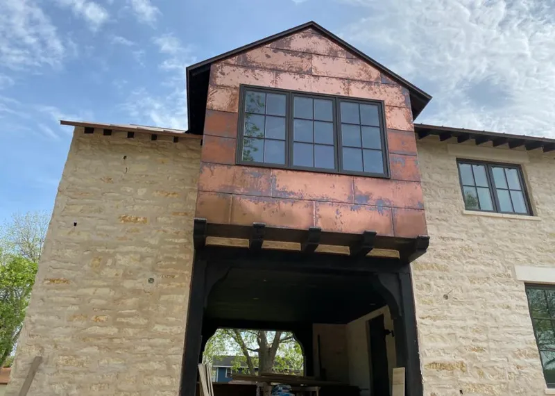 Copper metal panel facade on a stone building for Skylight Installation in Mendham